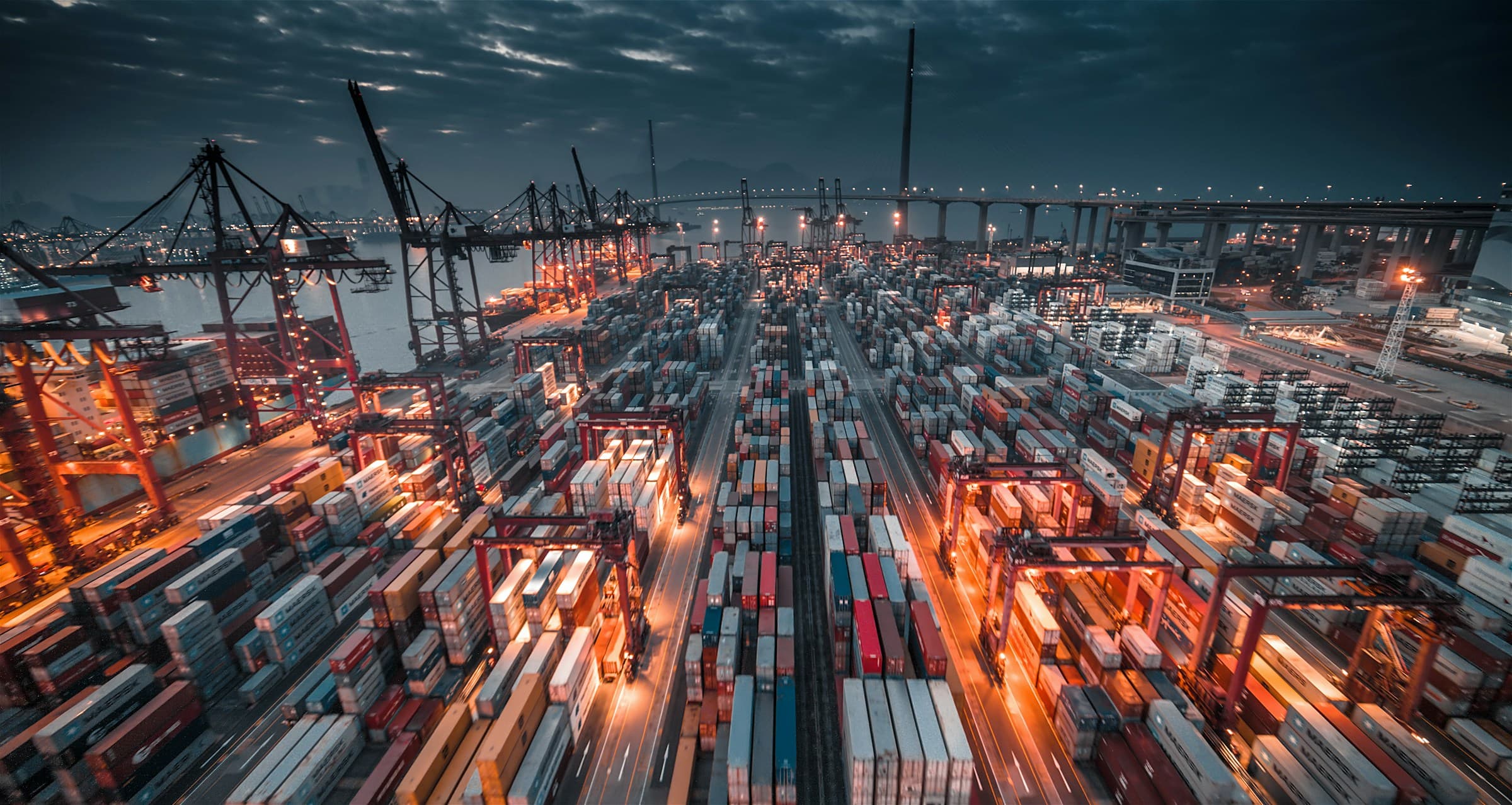 A commercial vessel on an export or import route, wide industrial frame