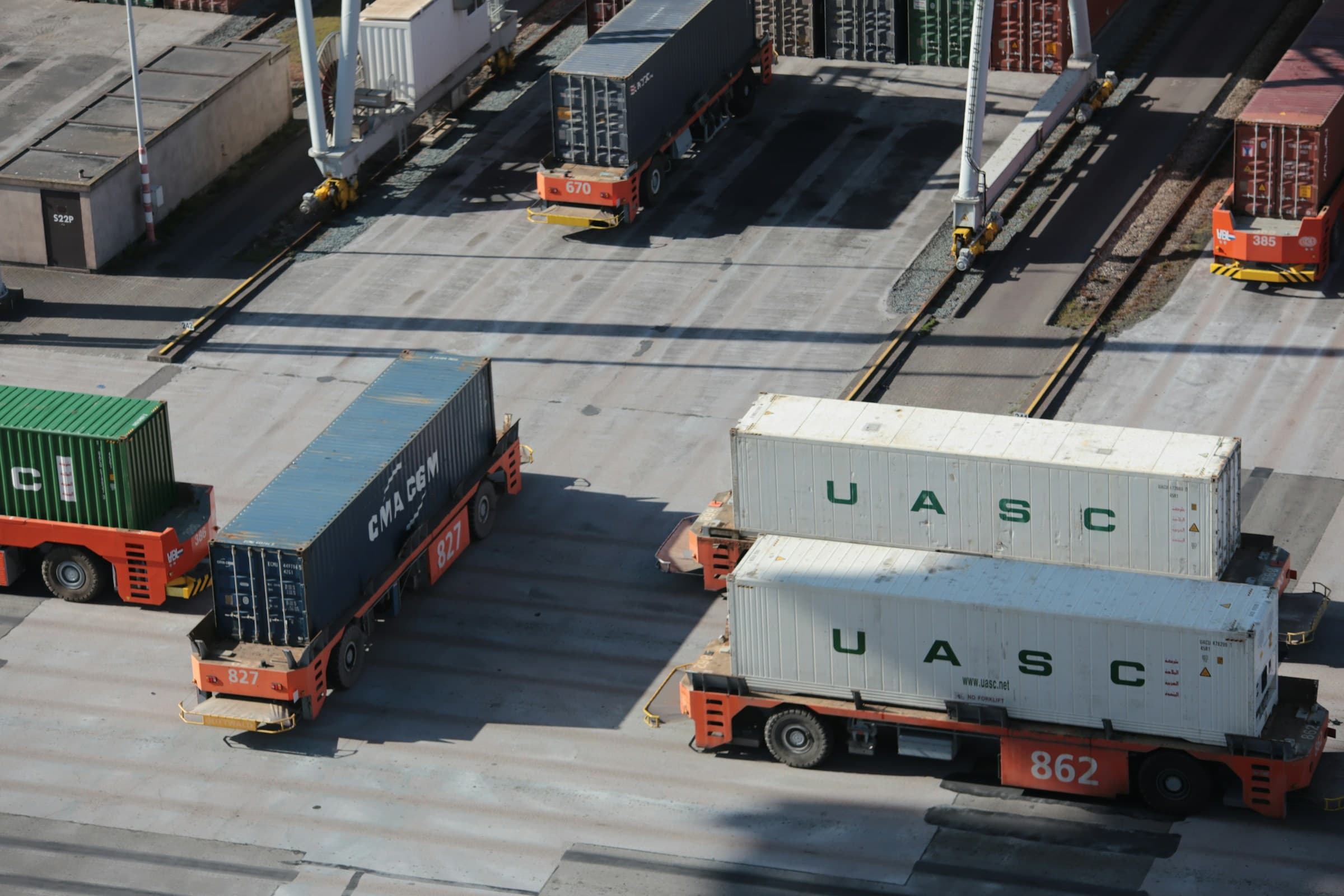 A vessel at berth together with road transport